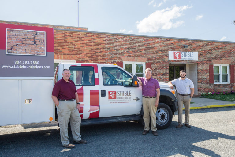 Stable Foundations foundation repair team standing next to company vehicle